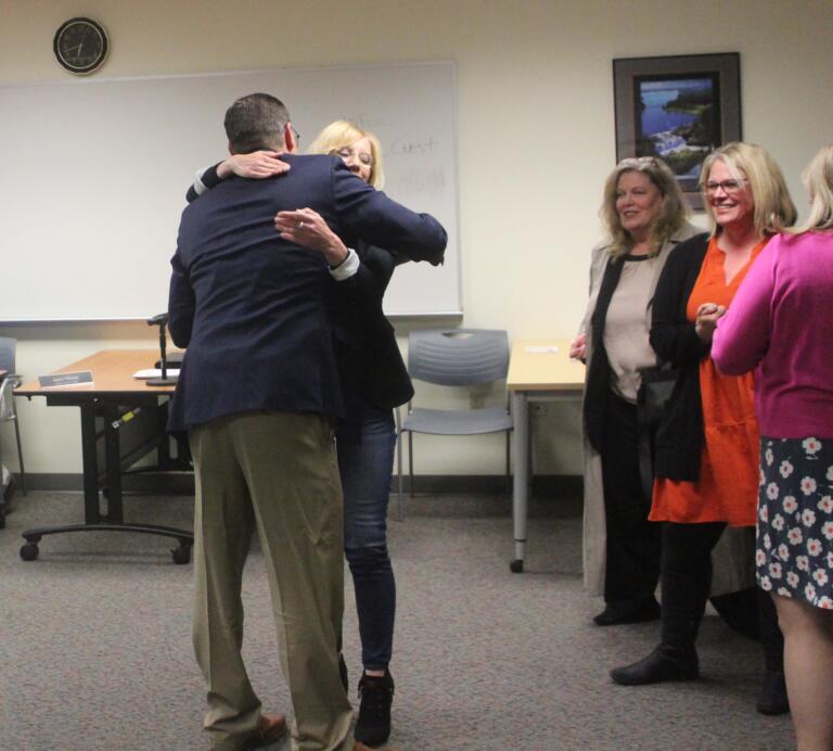 Aaron Hansen (left), an assistant superintendent for the Washougal School District and the former principal of Washougal High School, hugs WSD Superintendent Mary Templeton after a Washougal School Board meeting held April 30, 2024, during which the Board named Hansen as Templeton's interim replacement while the district seeks a new, permanent superintendent of schools.