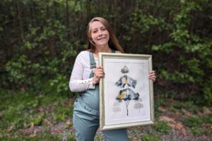 Washougal resident Makayla Blum holds one of her art pieces in April 2024. Blum is one of 23 local studio artists participating in the 2024 Washougal Studio Artists’ 2024 Spring Studio Tour. (Photo courtesy of Makayla Blum)