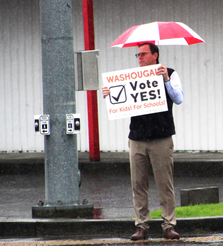 Washougal School District Assistant Superintendent Aaron Hansen waves a &ldquo;Vote Yes for Washougal Schools&rdquo; sign in Washougal, on Monday, April 24, 2023.