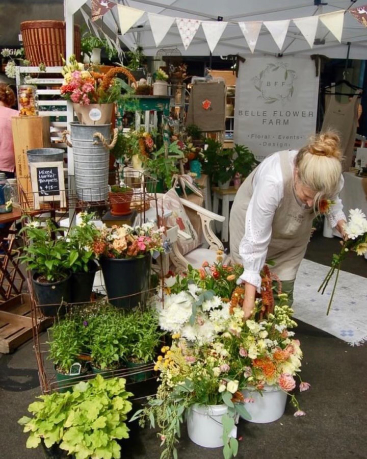 Pam Richey Curtis, owner of Belle Flower Farm, arranges flowers at the 2022 Camas Vintage & Art Faire. (Photo courtesy of Belle Flower Farm) 