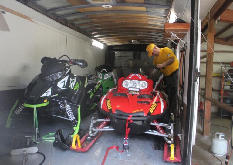 Doug Flanagan/Post-Record   Silver Star Search and Rescue rescue coordinator Rick Blevins examines one of the organization&#039;s snowmobiles at East County Fire and Rescue&#039;s Station 92 on May 13.