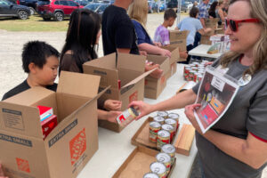 IMPACT Camas-Washougal volunteers help sort canned food in 2023. (Contributed photo courtesy of Rene Carroll)