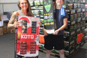 Washougal Grad Night volunteers Katy McCallister (left) and Erica Allen show mortar-style fireworks available for sale at Mean Gene Fireworks in Camas, Tuesday, July 2, 2024. Mean Gene's donates to local grad nights each year. McCallister, the parent of twin Washougal High seniors and Allen, a 2023 Washougal High graduate, say the fireworks funding is critical, and that organizers of the annual Washougal High School Grad Night would have a tough time finding alternative revenues. (Photos by Kelly Moyer/Post-Record)