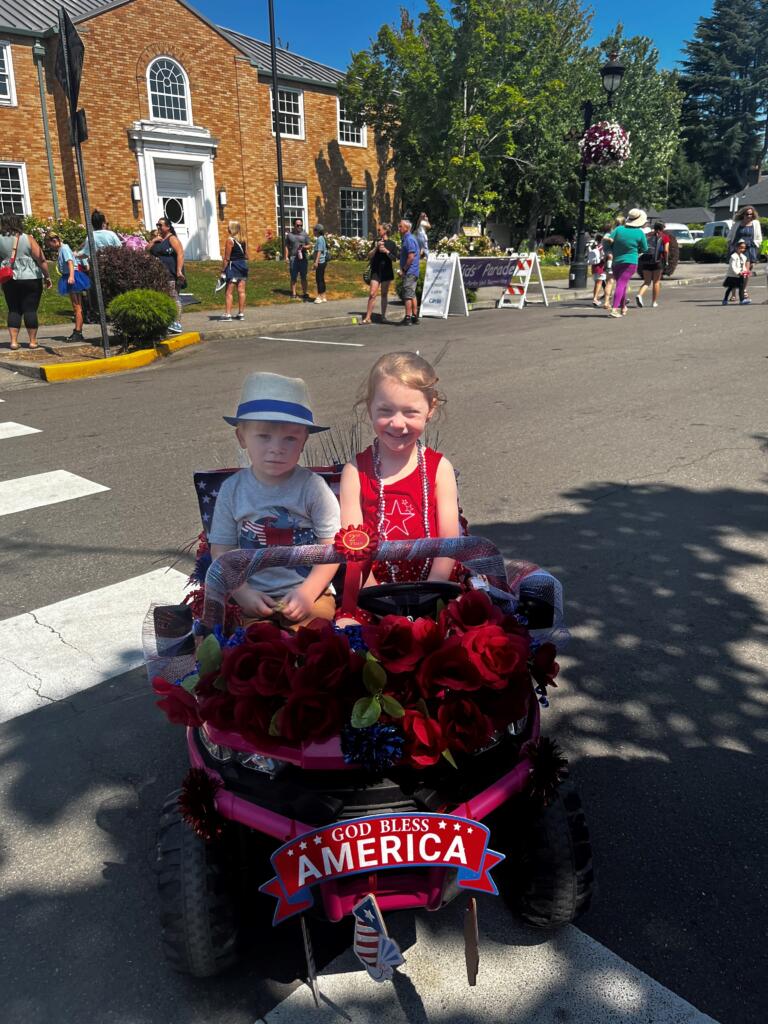 Siblings Rowan and Emma E. show their second-place nonmotorized award-winning entry in the 2024 "America the Beautiful" Camas Days Kids Parade, Friday, July 26, 2024.