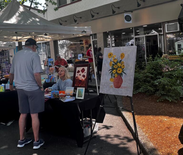 Vendors greet visitors on Northeast Fourth Avenue in downtown Camas during the first day of the 2024 Camas Days festival, Friday, July 26, 2024. (Kelly Moyer/Post-Record)