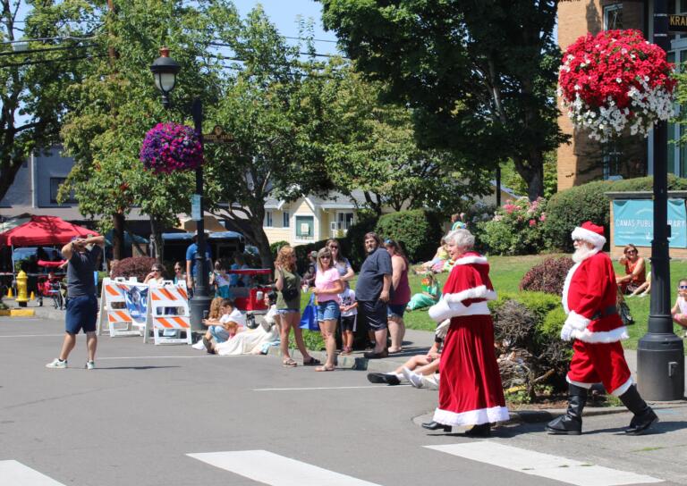 Santa and Mrs. Claus, also known in Camas-Washougal as Dennis and Kooky Helland, greet community members at the 2024 Camas Days festival in downtown Camas, Friday, July 26, 2024. (Kelly Moyer/Post-Record)