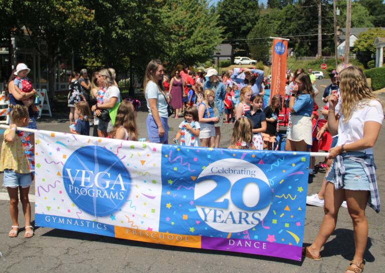 Members of the Vancouver Elite Gymnastic Academy (VEGA) prepare for the start of the 2024 Camas Days Kids Parade, Friday, July 26, 2024. (Kelly Moyer/Post-Record)