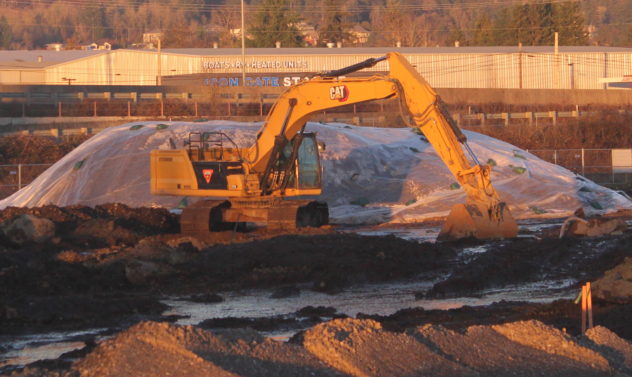 An excavator sits at the Hyas Point waterfront development construction site on Wednesday, Jan. 15, 2025. (Doug Flanagan/Post-Record)