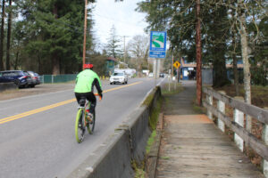 A bicyclist heads north on Northeast Everett Street near the Lakeside Market in Camas, Friday, Feb. 21, 2025. (Kelly Moyer/Post-Record)