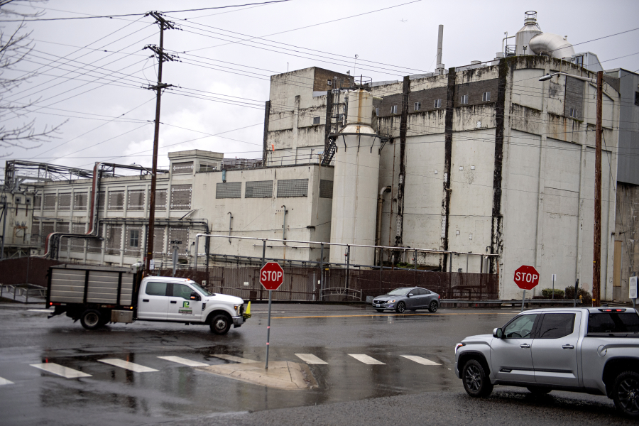 Motorists pass by the Georgia-Pacific mill in Camas on Monday morning. (Amanda Cowan/The Columbian)