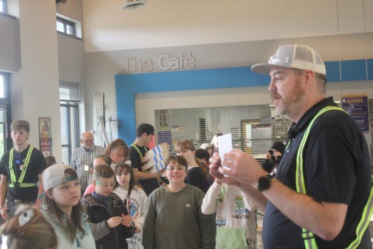 Washougal High School woodshop teacher Brent Mansell provides instructions to Columbia River Gorge Elementary School students at the start of the toolbox project at the school Feb.