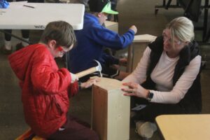 Columbia River Gorge Elementary School student Dexter Mitchell constructs a toolbox with the help of Washougal School Board President Sadie McKenzie at the school Feb. 25, 2025. (Doug Flanagan/Post-Record)