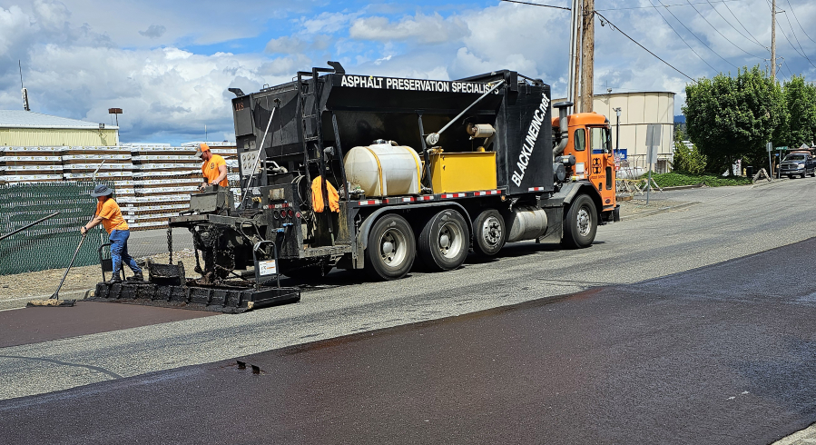 Photo contributed by the city of Washougal
Blackline Inc. employees conduct slurry seal treatments on 32nd Street in Washougal.