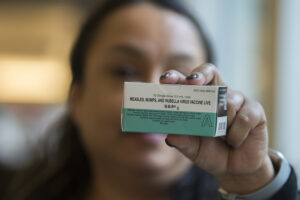 Registered nurse Diana Byrd holds a box containing the measles vaccine at the Kaiser Permanente Cascade Park office Feb. 4, 2019. (Amanda Cowan/The Columbian files)