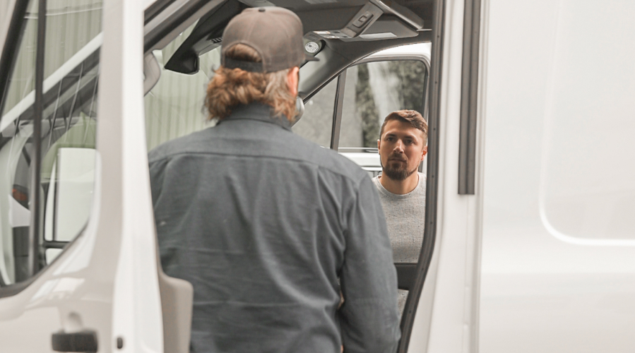 Washougal resident Ethan Sweet, right, talks with Van Haus Conversions owner Erik Ferjancic on either side of his adventure van earlier this year. (Contributed by Brooke Sweet)