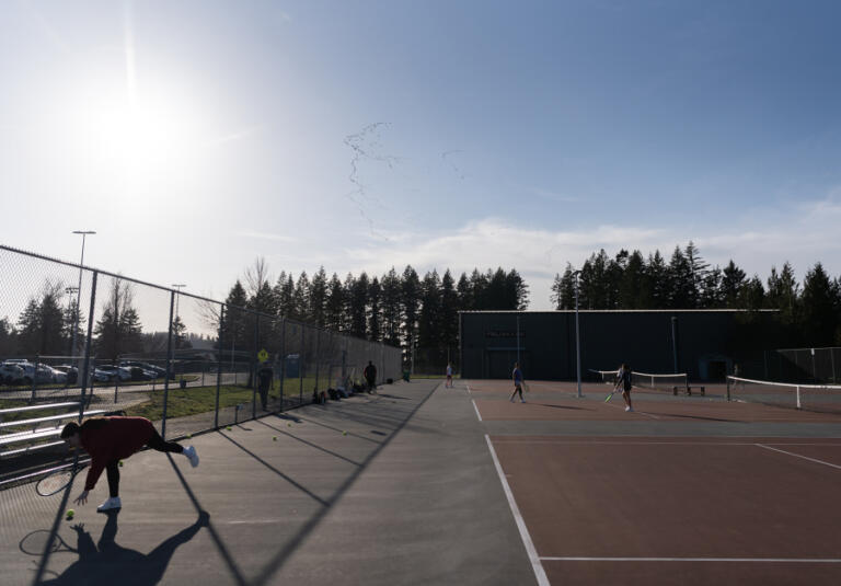 Geese fly over the Camas High School tennis courts on Friday during practice at the school.