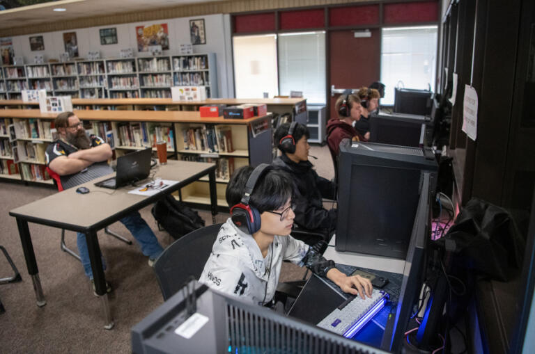 Prairie High School&rsquo;s esports team plays Valorant against Camas High School on Wednesday at Prairie High School. The Falcons mounted a furious comeback against Camas but ultimately lost 13-12. At left is Prairie esports coach Simeon Redberg. At top, an esports team member looks at a monitor displaying Super Smash Bros. Ultimate during practice March 19 at Prairie High School.