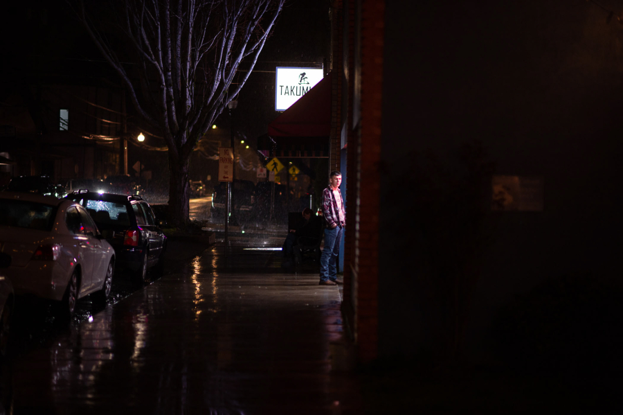 Light spills from the Eagle’s Lodge in downtown Washougal, which lacks much in the way of street lighting. Washougal City Councilor Molly Coston is advocating for the city of Washougal to upgrade the lighting and brighten a dark downtown. (James Rexroad/for The Columbian)