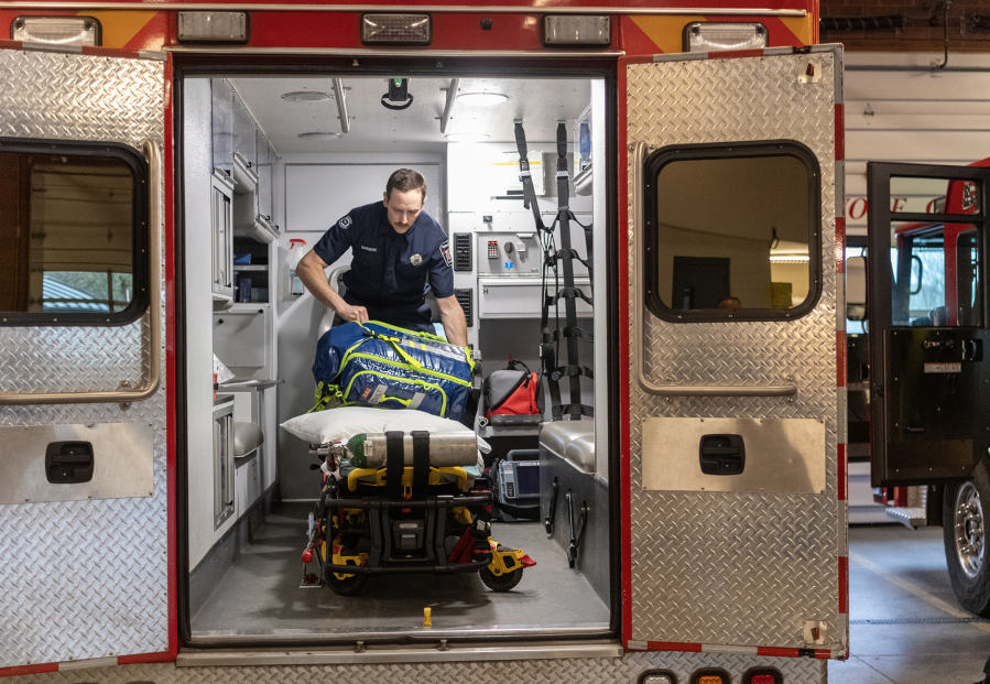 Firefighter-paramedic Nate Barmore checks equipment inside an ambulance Friday at the Camas-Washougal Fire Department’s Station 42 in Camas. If approved by voters April 22, a new Camas-Washougal Regional Fire Authority would offer free ambulance transport services to residents. (Taylor Balkom/The Columbian)