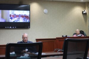 Martin Elzingre, on screen, speaks to members of the Camas City Council, including council members John Nohr, center, and Jennifer Senescu, right, while city attorney Shawn MacPherson, left, looks on during a special council meeting Tuesday evening, April 8, 2025, to interview and appoint an applicant to the council’s Ward 2 seat left vacant in February after the unexpected resignation of longtime Councilor Bonnie Carter. (Kelly Moyer/Post-Record)