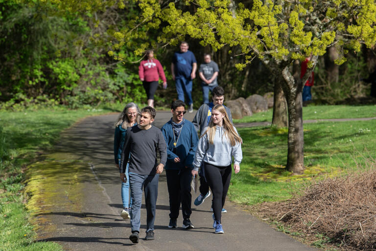 Volunteers Laura Hershberger, left in teal coat, and Makena Campbell, right in gray, lead athletes in the Mountain Tops class along the Heritage Trail in Camas on April 3. Mountain Tops, a program that hosts twice-weekly exercise classes for young adults with physical, mental or emotional developmental disabilities, is growing and needs more volunteers. &ldquo;It&rsquo;s humbling and joyous,&rdquo; Hershberger said of volunteering with the Mountain Tops program.