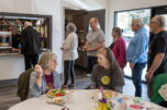 Washougal resident Tanya Irvin, left, enjoys a fresh salad while chatting with Vancouver resident Ann Wygal at the Washougal Community Center on Thursday afternoon. (Amanda Cowan/The Columbian)