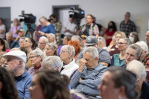 Audience members listen to U.S. Rep. Marie Gluesenkamp Perez, D-Skamania, answer questions Thursday during a town hall at the Luepke Center in central Vancouver. Hundreds of constituents lined up for the event with signs expressing their anger over Perez’s voting record. (Photos by Taylor Balkom/The Columbian)
