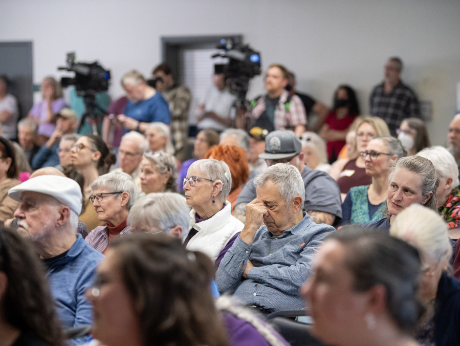 Audience members listen to U.S. Rep. Marie Gluesenkamp Perez, D-Skamania, answer questions Thursday during a town hall at the Luepke Center in central Vancouver. Hundreds of constituents lined up for the event with signs expressing their anger over Perez&rsquo;s voting record. (Photos by Taylor Balkom/The Columbian)