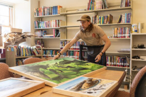 Artist Travis London sets an art piece on a table Friday, April 25, 2025, at the Camas Public Library. The Second Story Gallery, on the second floor of the Camas library, has selected London for its new artist-in-residence program. (Photos by Taylor Balkom/The Columbian)