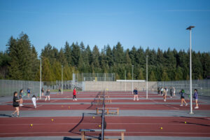 The Camas girls tennis team practices March 7, 2025, at Camas High School. The Camas School District is collaborating with U.S. Tennis Association to build a bubble over its outdoor tennis courts, which Camas athletics leaders say will help the Camas girls tennis team avoid rained-out practices and matches. (Taylor Balkom/The Columbian files)