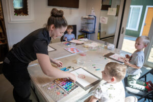 Instructor Sarah Ratcliff, clockwise from left, works with students Sonny Lapeze, 5, Jack Davis, 3, and Weston Lumley, 4, during art class Wednesday, April 23, 2025, at Opus School of the Arts in Camas. The school recently expanded into a second, adjacent building and now offers a “one-stop shop” for Camas-area families seeking youth arts classes in music, theater, dance and fine art. (Taylor Balkom/The Columbian)